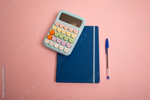 calculator and pen on notebook © Andrei