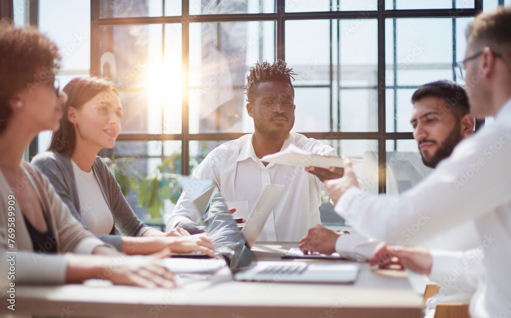 Fototapeta premium Employees working at computer together, discussing content