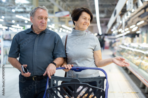 Elderly couple walks through a supermarket