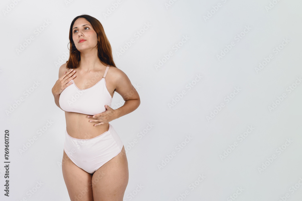 young latin woman with long hair in white underwear and white sports bra posing on white background young latin woman with long hair in white underwear and white sports bra posing on white background