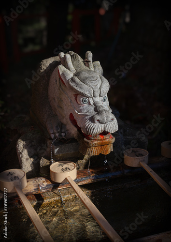 Dragon statue at a washbasin in Fushimi Inari Taisha shrine in Kyoto, Japan