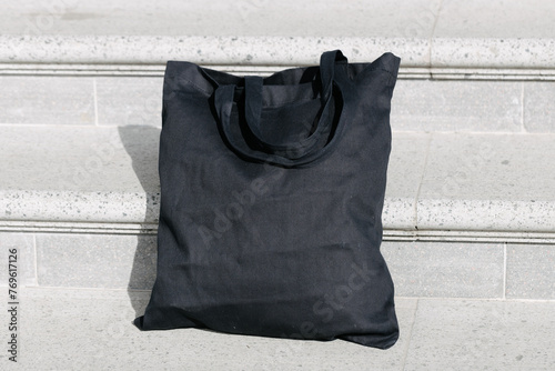 Black tote bag or eco cotton bag on stairs