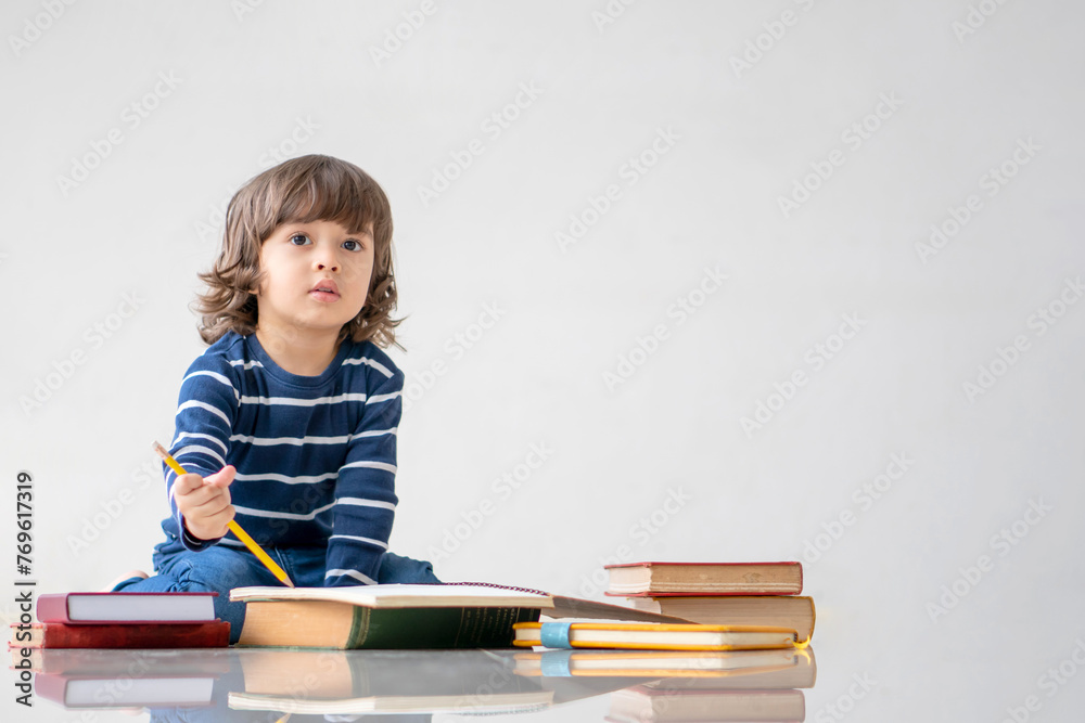 Education and back to school concept. Portrait of Happy little child boy learning to drawing and coloring on a book. Preschool children kids enjoy and fun study and doing homework at home. Education and back to school concept. Portrait of Happy little child boy learning to drawing and coloring on a book. Preschool children kids enjoy and fun study and doing homework at home.
