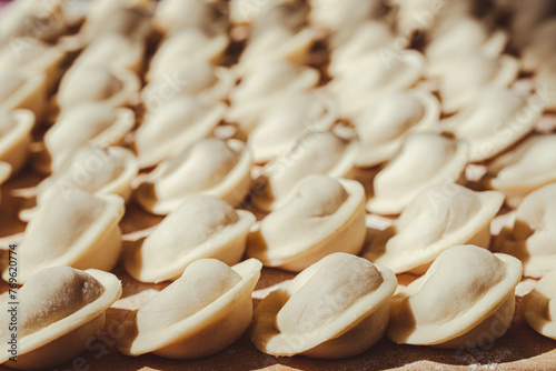 Prepared meat dumplings or pelmeni lying in rows