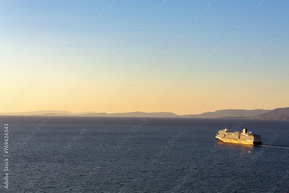 Cruise ship basking in the golden hour light, serene sea, sailing fromthe bay, trending pastel skies. Kusadasi, Aidyn, Turkiye (Turkey)