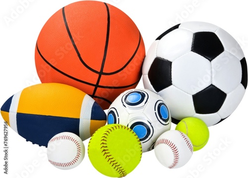 A collection of colorful sports balls including a soccer ball, basketball, baseball, American football, rugby ball, volleyball, and tennis balls, all piled together on a white background. © Muhammad