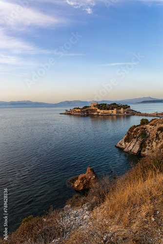 Sunset hues over Pigeon Island, Kusadasi, with serene sea and historic castle, a scenic blend of history and nature. Cover page, golden hour. Kusadasi, Aidyn, Turkiye (Turkey)