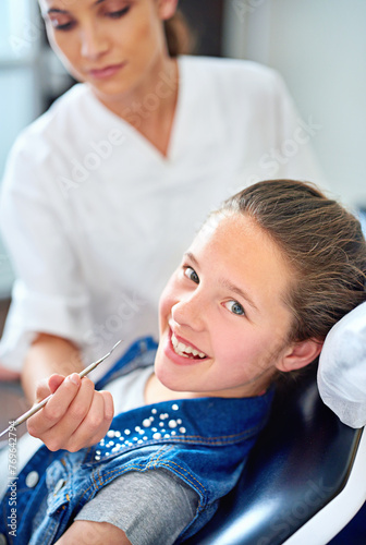 Girl, child and portrait at dentist for healthcare with dental tool, consultation or mouth inspection for oral health. Orthodontics, kid patient or hand for teeth cleaning, gingivitis or medical care
