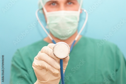 Young doctor surgeon orthopedist with breathing mask and hood after surgery