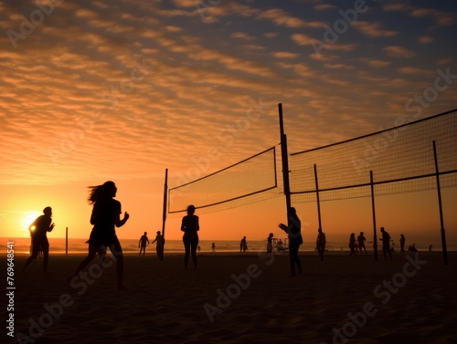 people playing beach volleyball on the sunset