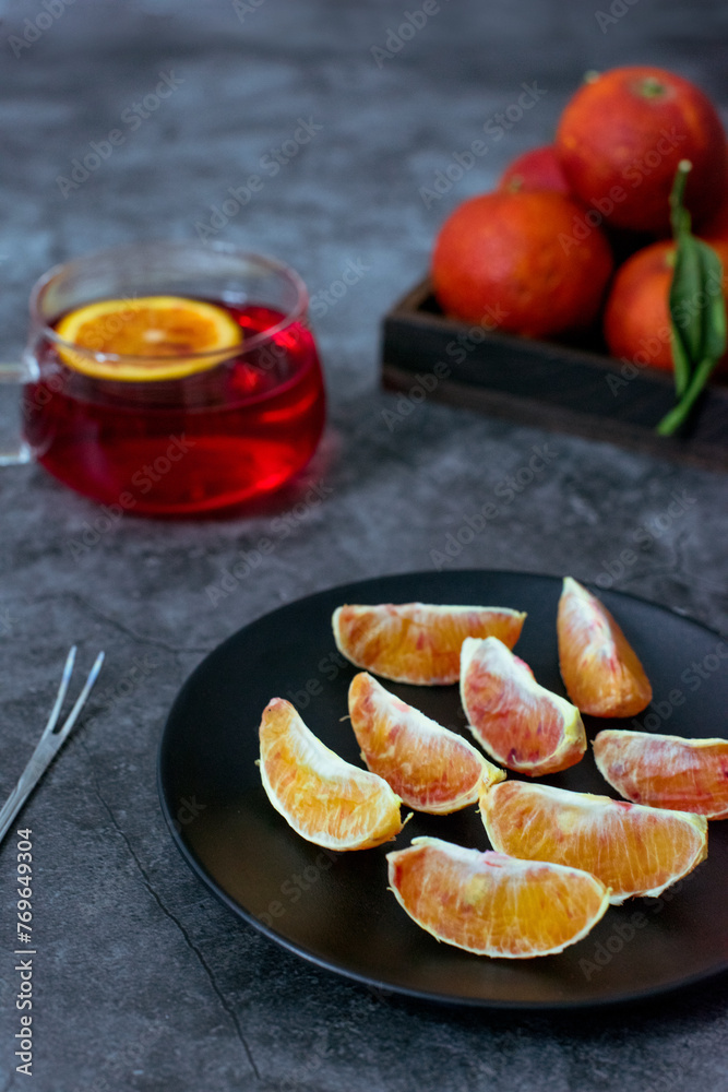 Blood oranges in wooden box or black plate Blood oranges in wooden box or black plate