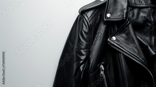 A woman's black leather jacket isolated against a white background, showcasing a sleek design