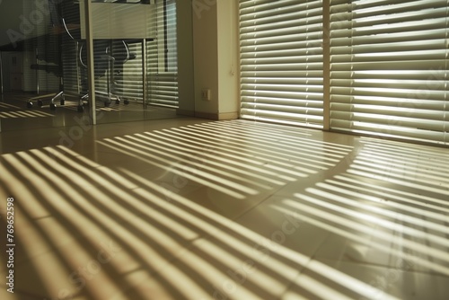 office with blinds halfopen casting striped shadows on floor photo