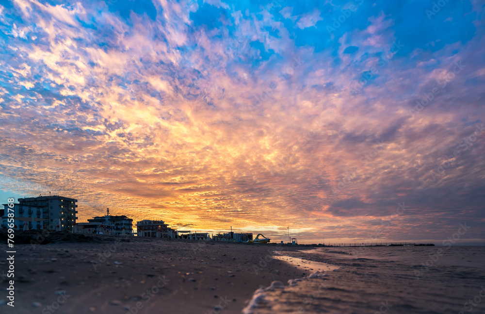 Obraz premium Sunset on the Rimini beach, Italy
