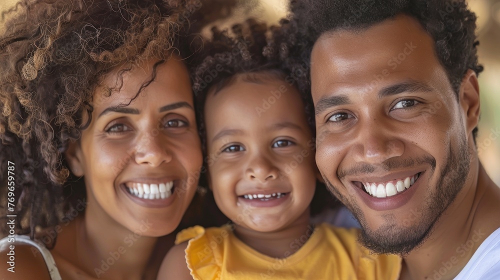 A joyful family moment captured with a smiling man woman and child sharing a warm embrace. A joyful family moment captured with a smiling man woman and child sharing a warm embrace.