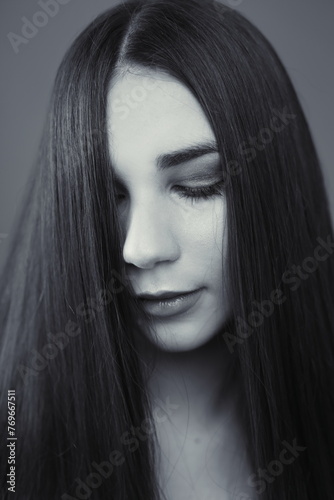 photograph of young woman with dark straight hair