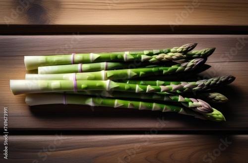 Bunch of fresh green asparagus spears on rustic wooden table. View from above