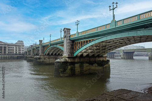 Southwark Bridge Over Low Tide River Thames in London Winter Day photo