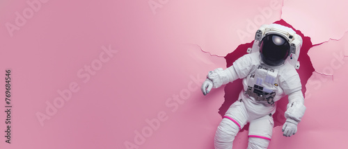 A poised astronaut rips pink paper, symbolizing entry into the unknown and innovation