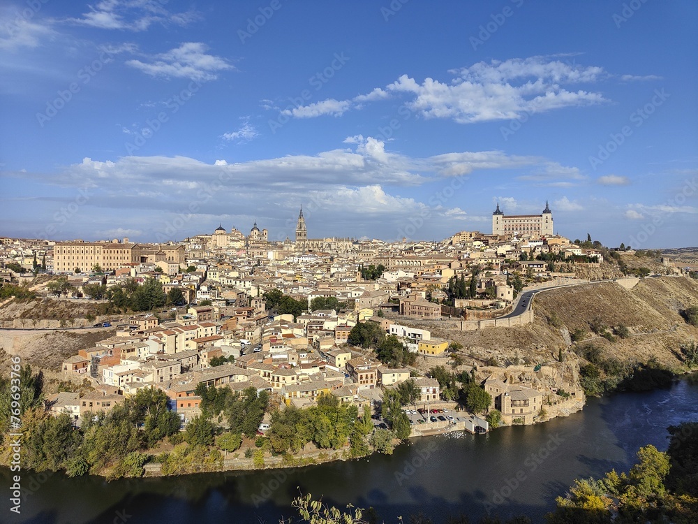 Breathtaking view of the city of Toledo, Spain, situated atop a hill overlooking a river.