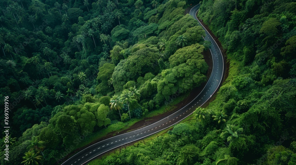 Aerial top view beautiful curve road on green forest in the rain season. Aerial top view beautiful curve road on green forest in the rain season.