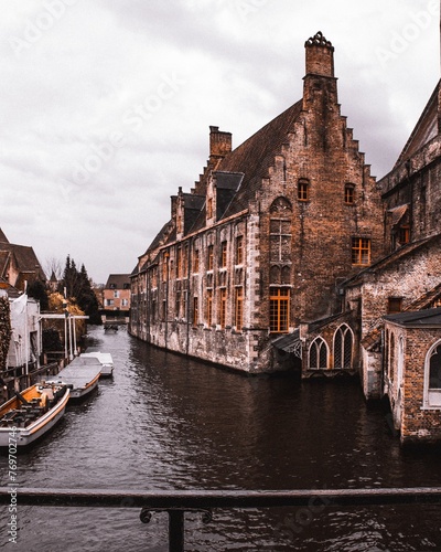 Scenic view of the city of Bruges in Belgium, featuring a river with buildings on either side.