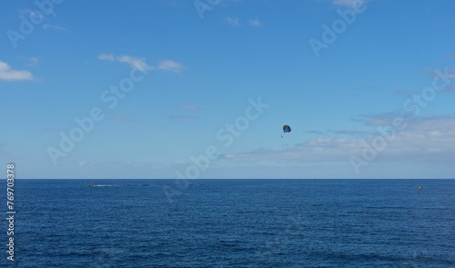 a couple of people that are in the water flying kites © Wirestock