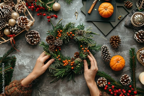 A person decorates a wreath with pine cones and oranges in a DIY Holiday Crafts Showcase setting