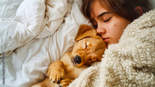 A cute puppy cuddling with its owner in bed.