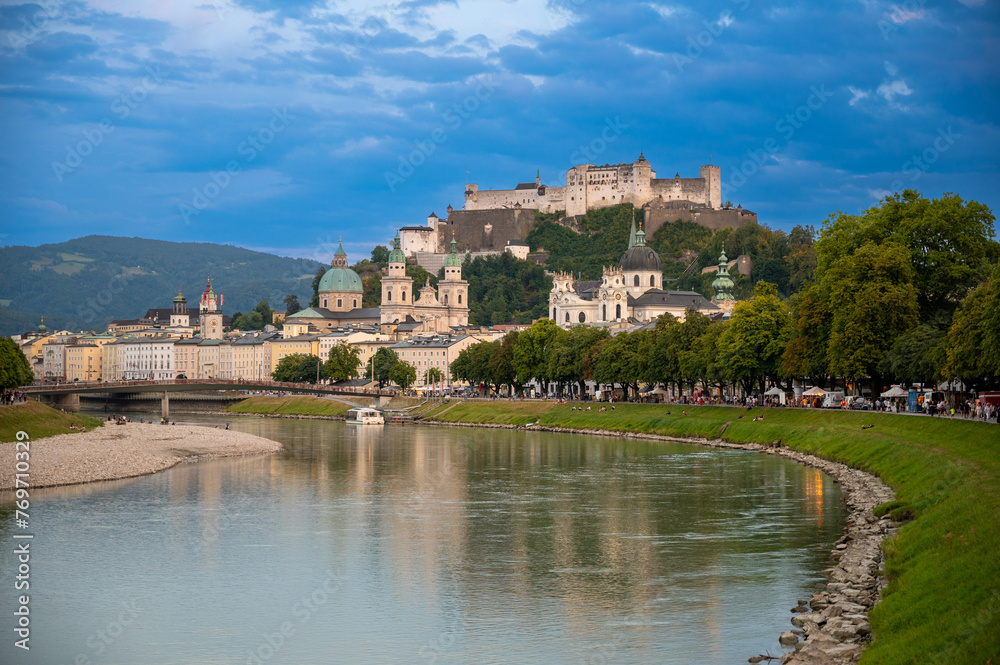Salzburg, Austria, August 15, 2022. Golden hour shot towards the historic center. Highlighted is the fort at the top of the hill which dominates the landscape.
