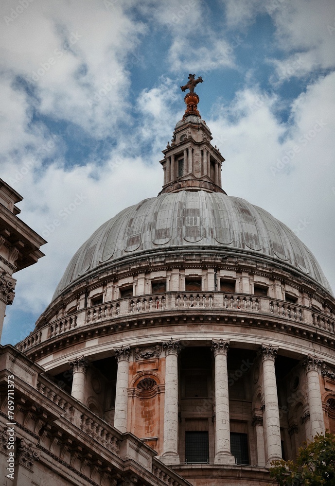 Low angle of St Paul's Cathedral under a cloudy sky in London, England, UK