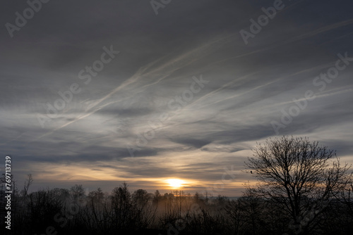 Alencon  France - 03 20 2024  View of a colorful sunrise with mist in the Normandy countryside.