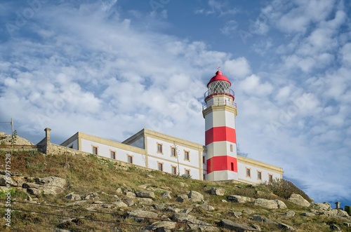 Silleiro Lighthouse against a backdrop of a dramatic cloudy blue sky photo