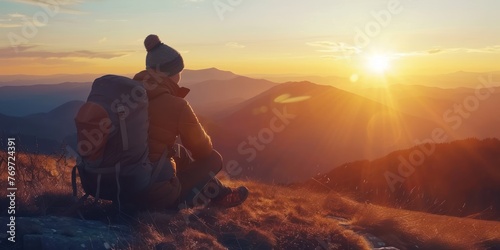 A solo traveler admiring a breathtaking sunset over a mountain range