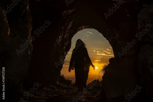 A silhouette of a person walking through a cave, their figure stark against the darkness of the cavern