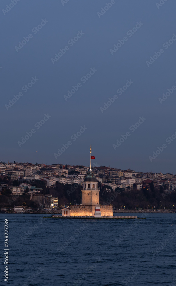 Beautiful sunset over Bosphorus with famous historical Maiden's Tower (Kiz Kulesi) also known as Leander's Tower, symbol of Istanbul, Turkey. Scenic travel background for wallpaper or guide book.