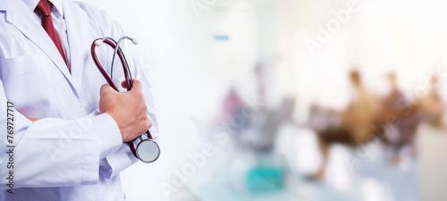 doctor hold stethoscope in hand at hospital with blur people background, healthcare and medical concept