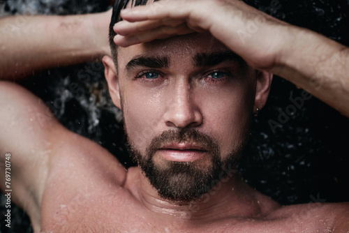 Closeup portrait of handsome bearded man with wet skin and hair