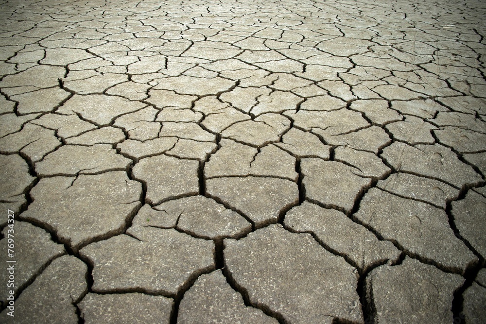 Closeup shot of cracked ground surface with jagged patterns and textural details visible. Closeup shot of cracked ground surface with jagged patterns and textural details visible.
