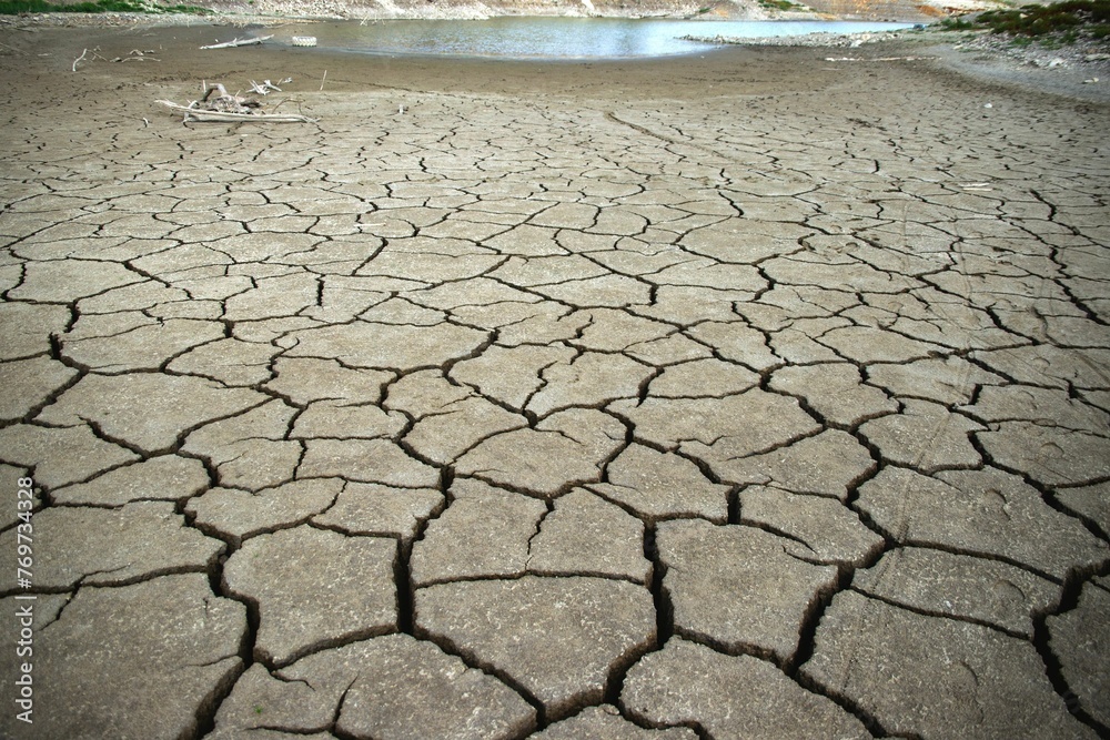 Closeup shot of cracked ground surface with jagged patterns and textural details visible. Closeup shot of cracked ground surface with jagged patterns and textural details visible.
