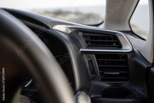 Closeup view of air vent inside modern car dashboard photo