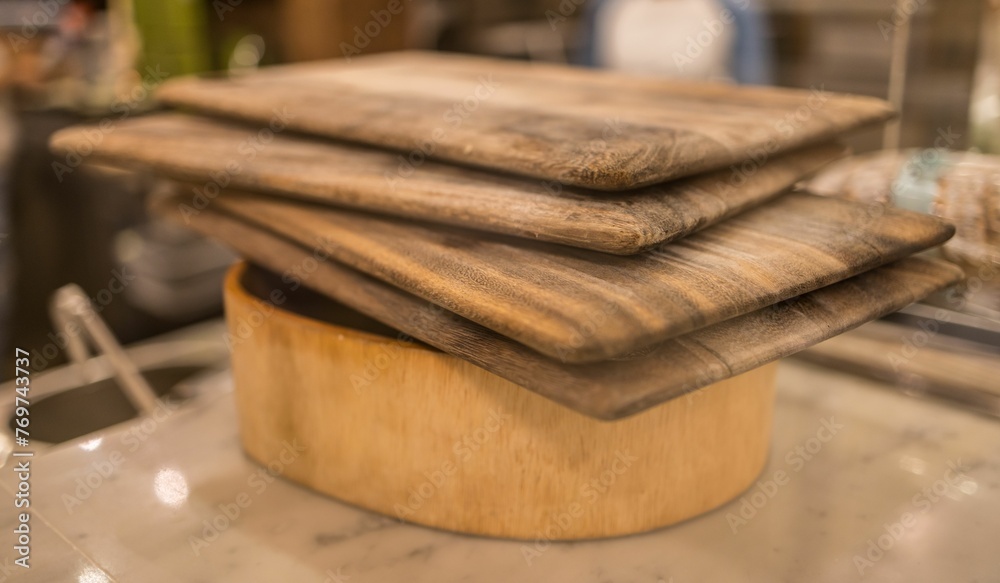 Closeup of wooden cutting boards on the counter with a blurry background