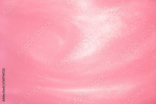 Vibrant pink background with white particles photo