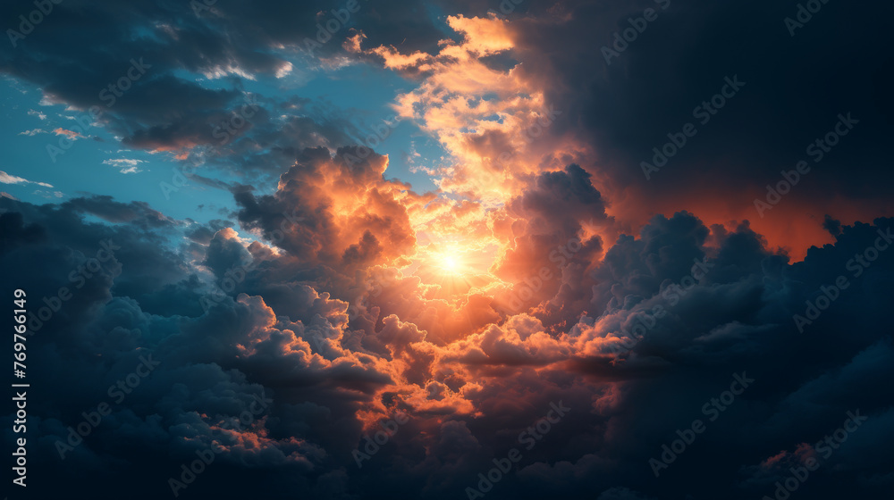 Dramatic cloudscape at sunset with glowing sun and rays