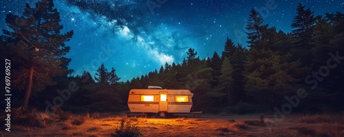 Caravan under a starry sky in a forest clearing © cac_tus