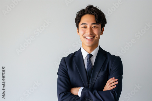 笑顔で腕組みをする若いビジネスマン、アジア人、日本人
