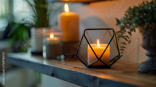 A candle burning inside a geometric holder