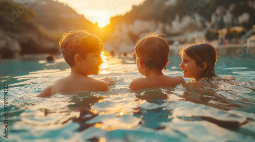 A happy family has fun in a natural thermal pool. photo