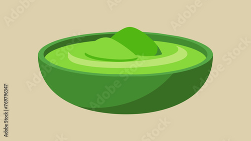  A closeup of a bowl filled with green paste made from indigenous plants used in traditional medicine to treat skin ailments.