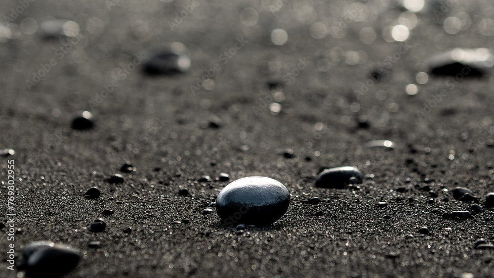 Volcanic black rocks and sand on the black sand beach in Reynisfjara in Iceland on March 2024 - obrazy, fototapety, plakaty 